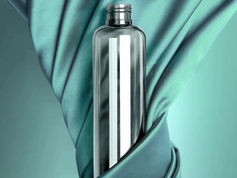 Clear PackGroup bottle on turquoise fabric
